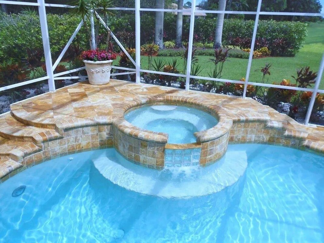 A pool with a jacuzzi in the middle of it